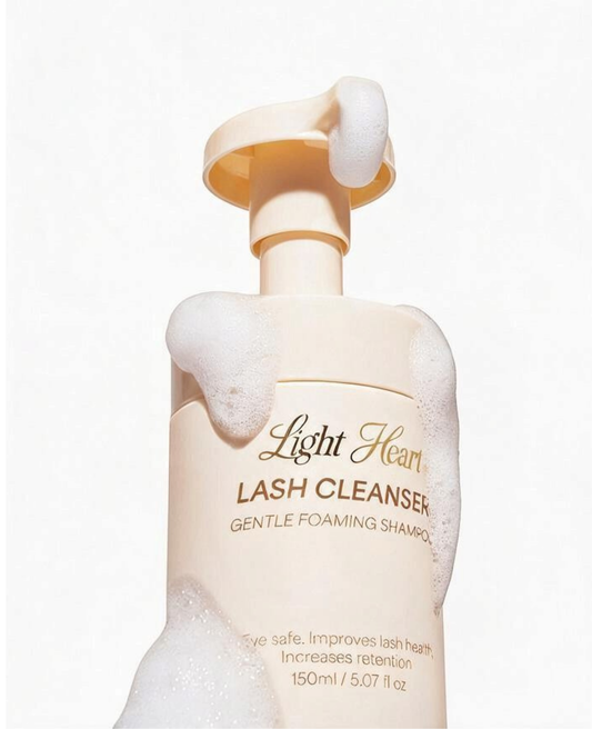 Light Heart Beauty Gentle Foaming Lash Cleanser bottle covered in soft white foam for daily eyelash extension care